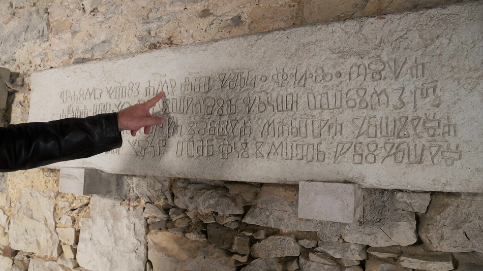 My friend Alen points at Glagolitic script in the smallest town in the world, Hum. This is an ancient writing used only in Great Moravia, Bulgaria, and last kept alive by the Croats.