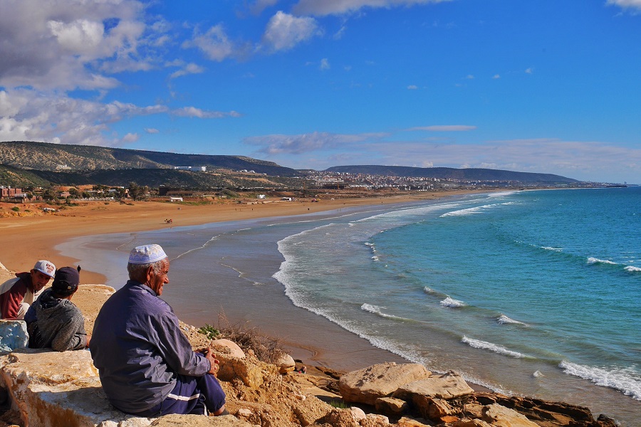 An Islamic man enjoys a day at the beach.