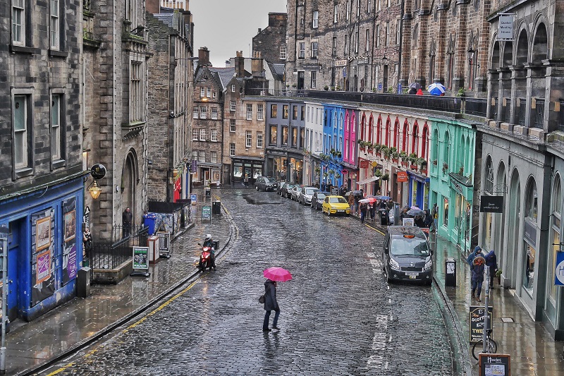 Woman with a pink umbrella crosses Bow/Victoria Street in Edinburgh. This is probably one of my all-time favourite shots I’ve taken. I waited for someone with a colourful umbrella for over 5 minutes in the blowing wind and rain and snow. So happy with the result.