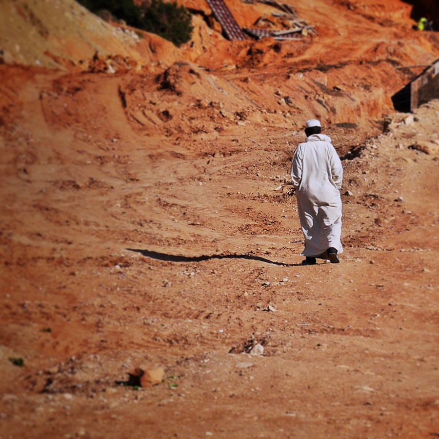 A Berber man strolls to the beach.